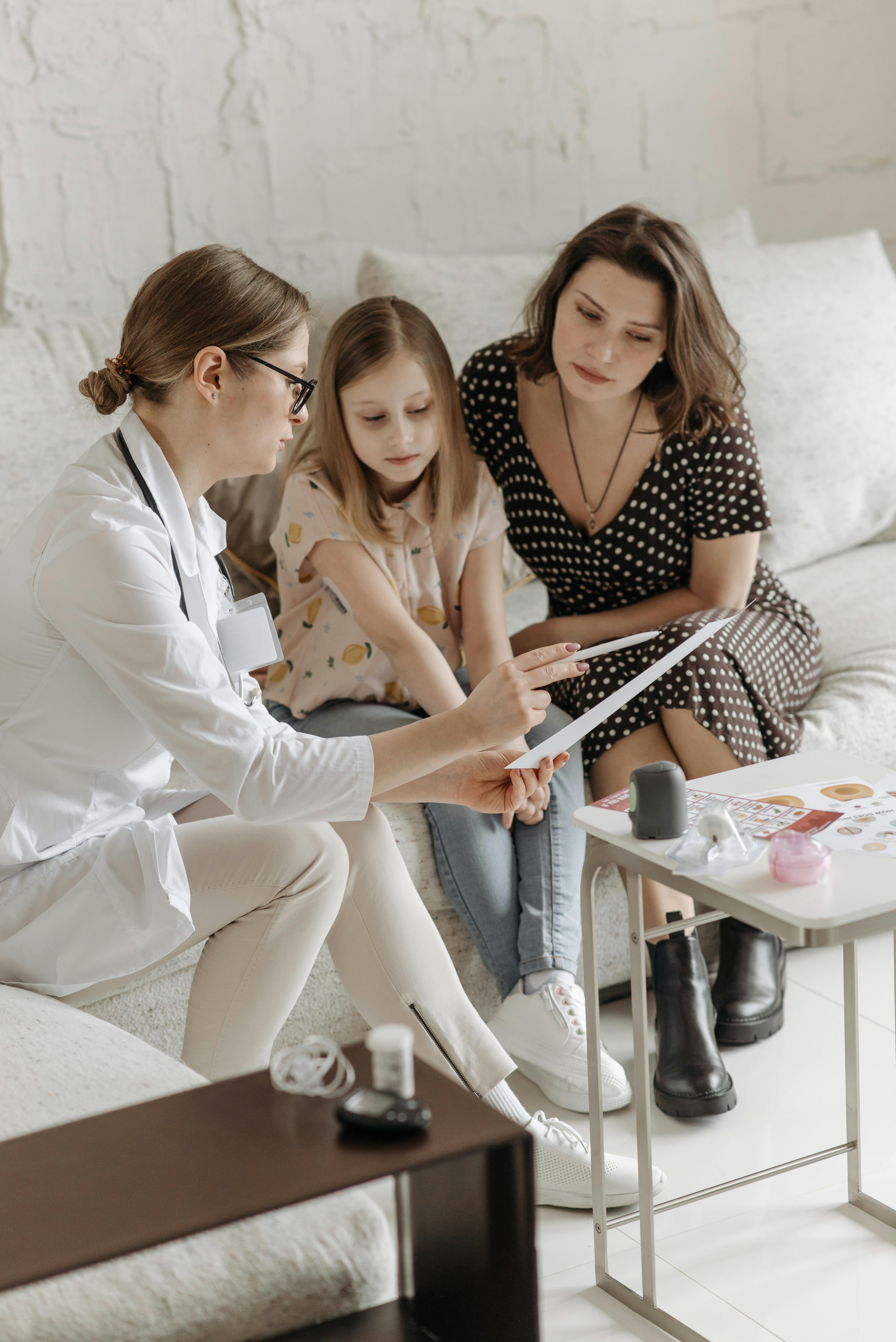 Occupational therapist reviewing a care plan with a parent and child